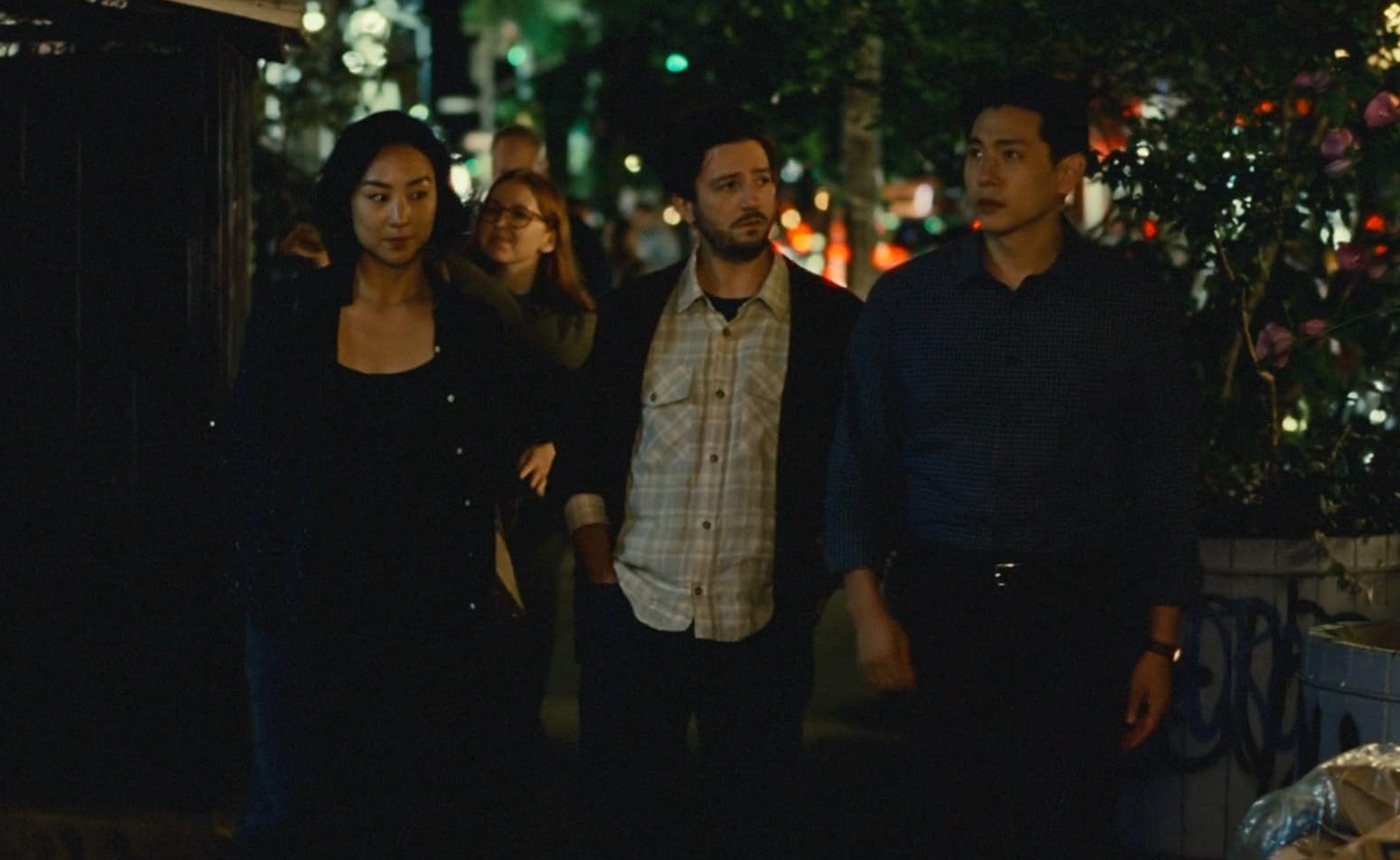 Nora, Arthur and Hae Sung walking together at night in New York, a still from Past Lives
